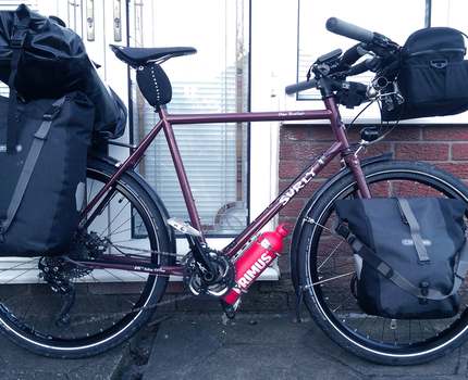 Photo of a bicycle near a wall of a building